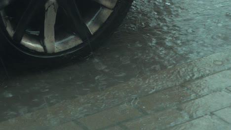 View-of-heavy-storm-hail-and-rain-falling-on-a-black-car,-nature-disaster,-climate-changes,-global-warming,-hot-summer-day,-medium-closeup-shot