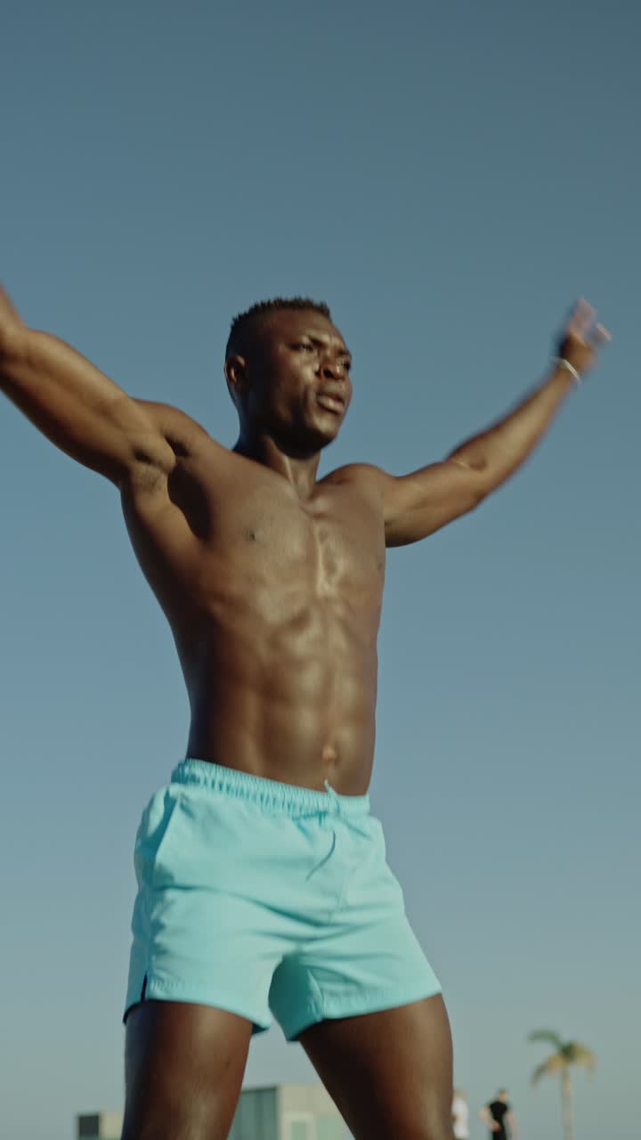 Athletic man exercising on the beach