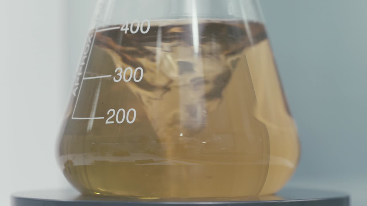 Stirring Test Tubes containing chemical liquids while working in a Modern Laboratory