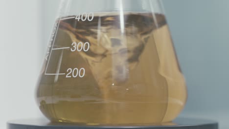 stirring test tubes containing chemical liquids while working in a modern laboratory