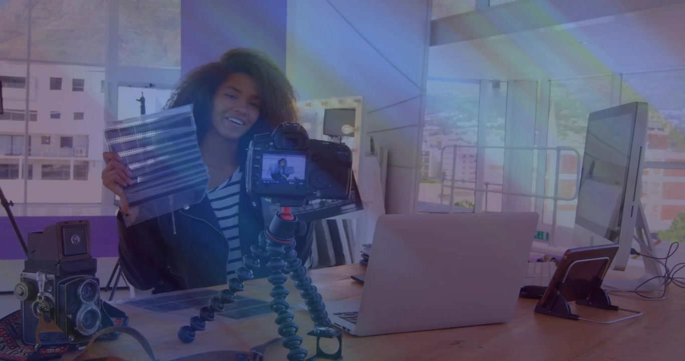 Female content creator reaching for slate on desk, snapping slate marking take for media production