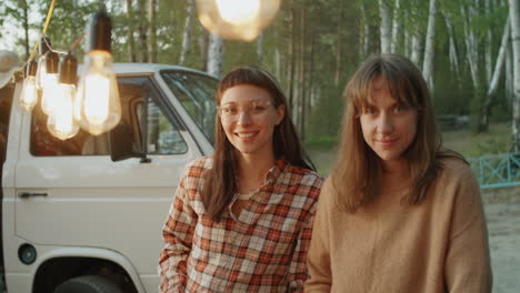 Portrait-of-Two-Young-Cheerful-Women-at-Campsite