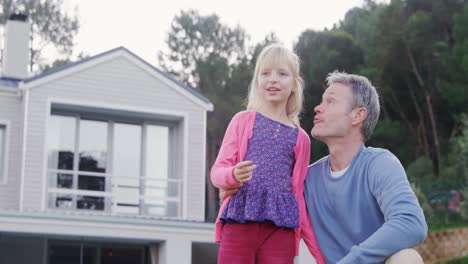 father and daughter looking at distance 4k