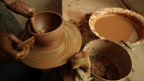 woman hands doing handmade product on potters wheel