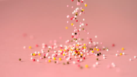 loads of sprinkles falling on pink surface