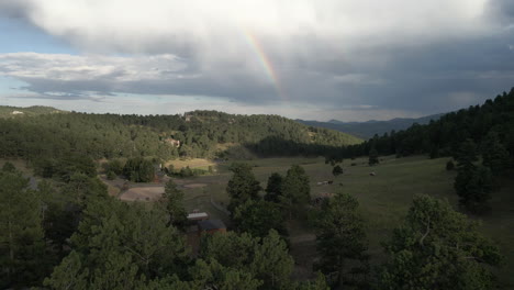 greenery nature over mountains with rainbow background in colorado, united states