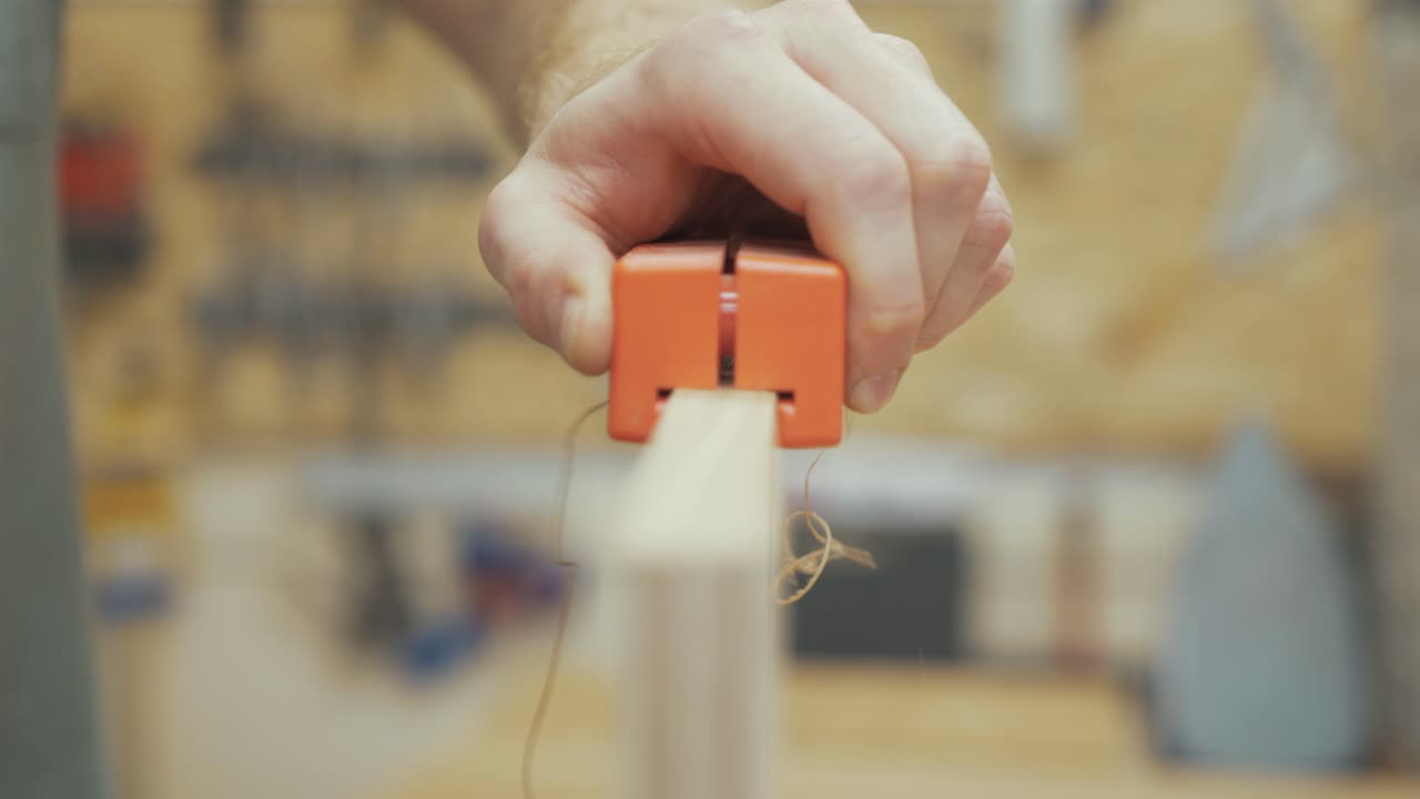 Carpenter using tool to trim white oak veneer, Medium Close Up