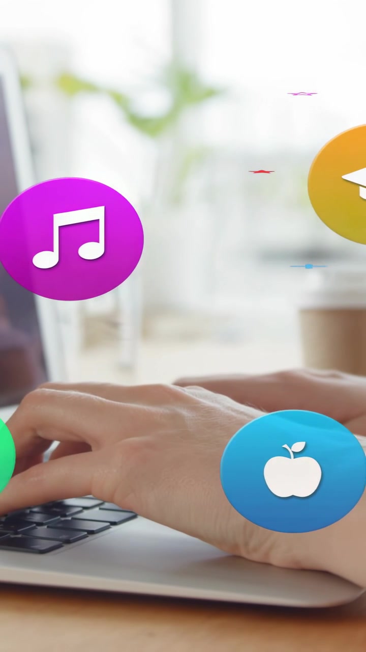 Vertical video: Woman typing at laptop, causing learning icons to emerge then float over hands