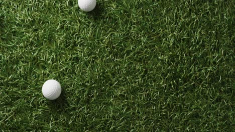 Close-up-of-golf-balls-on-grass,-copy-space,-slow-motion