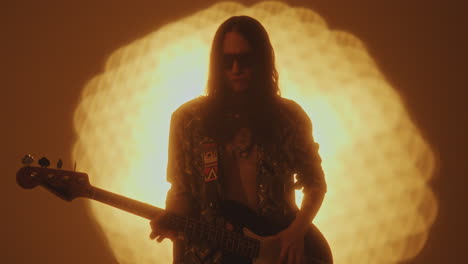rock musician playing the guitar during performance in studio