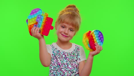 Smiling-child-girl-kid-holding-squeezing-anti-stress-pop-it-touch-screen-toys-simple-dimple-game