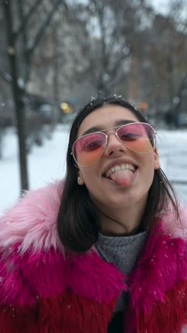 happy woman in pink fur coat in the snow