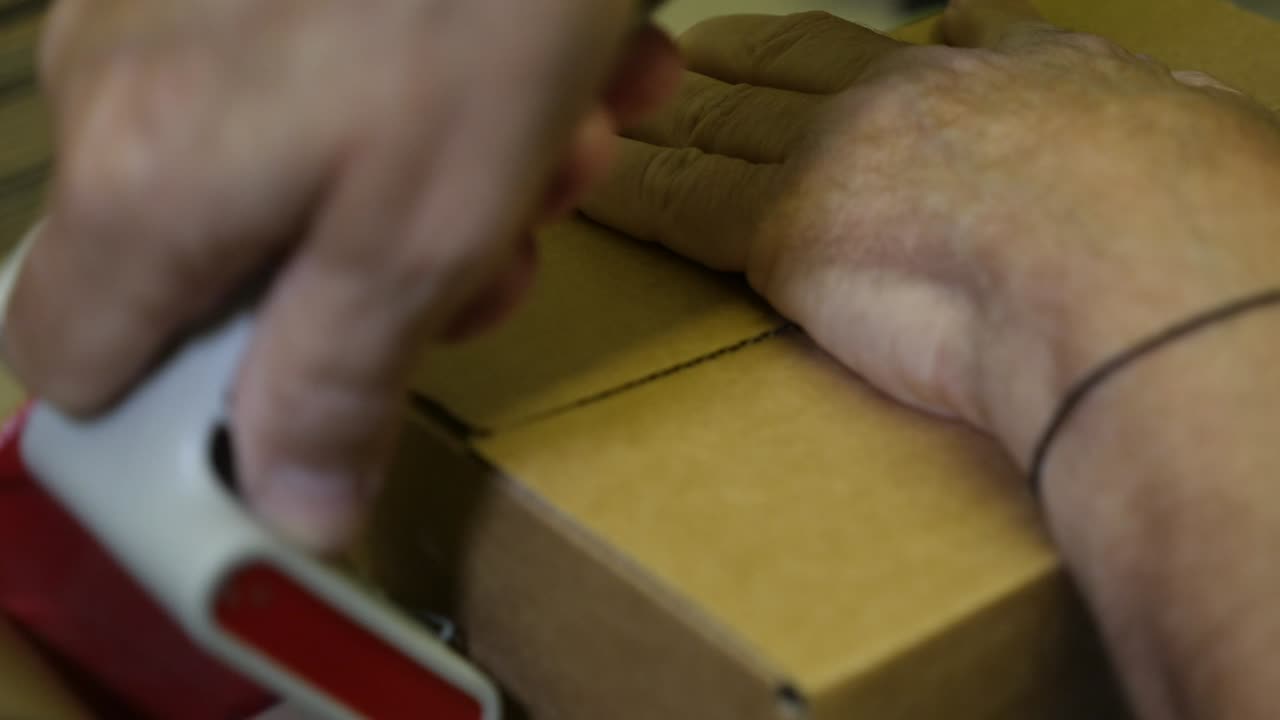 Packing a Cardboard Box with Packing Tape