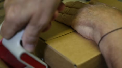 packing a cardboard box with packing tape