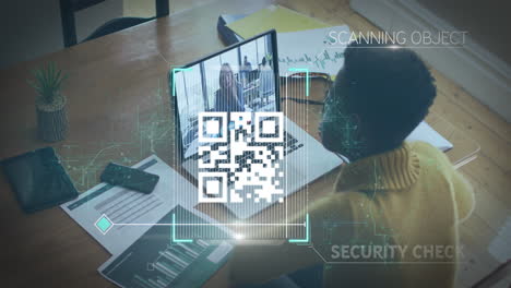 qr code scanning animation over person working at desk with laptop