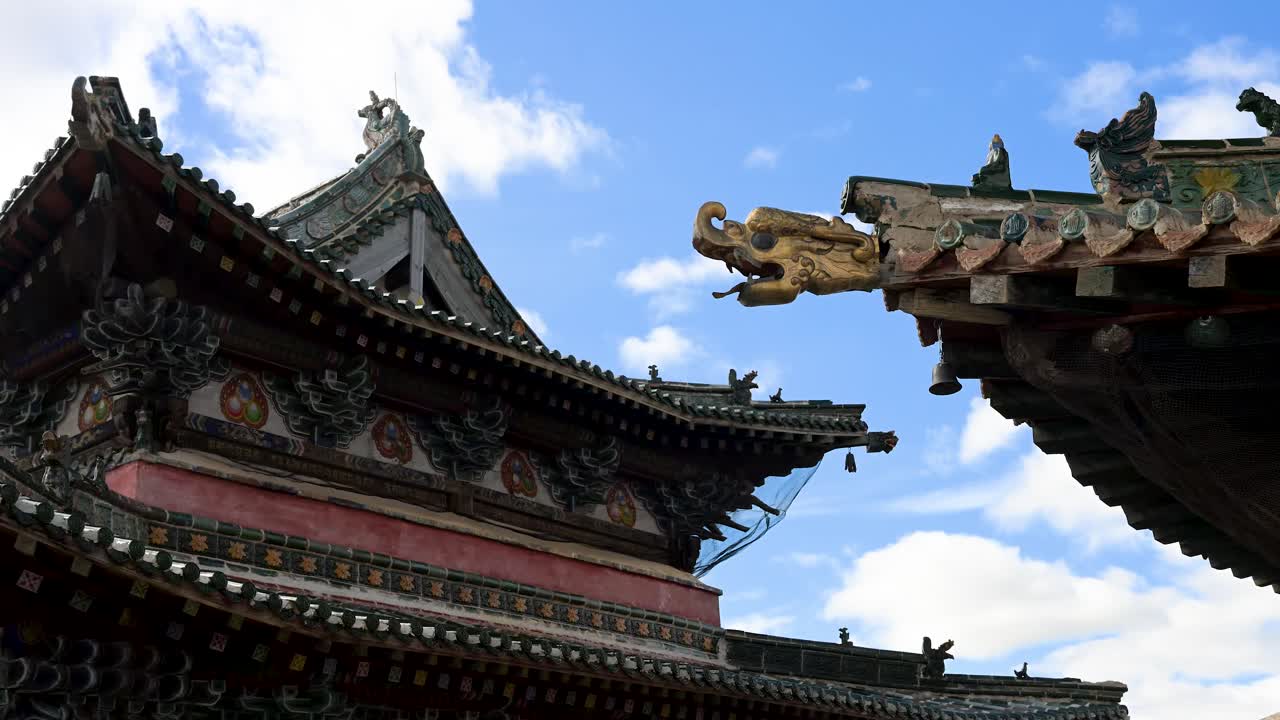 Weathered roof details of Mongolia's oldest monastery, Erdene Zuu. Features intricate clay figurines and dragon ornaments on the eaves of a sacred pavilion