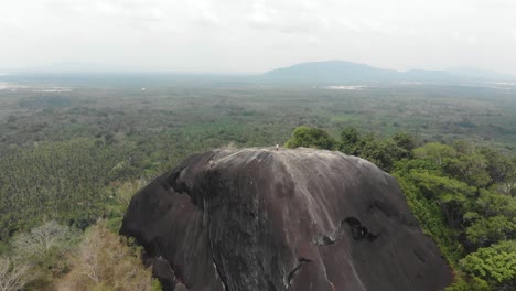 Big-granite-boulder-at-Batu-beginde-Belitung-Indonesia,-aerial