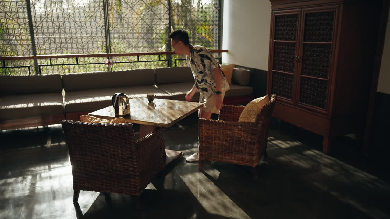 아시아 남자 소년은 달 ⁇ 한 차 한 잔을 만들고 앉아서 마시고