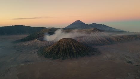 aerial cinematic view of bromo mountain as know as bromo volcano during the beautiful and orange sunrise of east java - indonesia