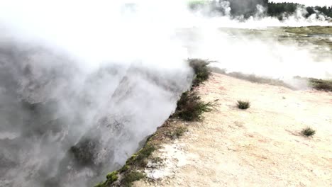 new zealand geysers, thermal steam of boiling water evaporating in north island of new zealand, thermal wonderland, geothermal active area, slow motion