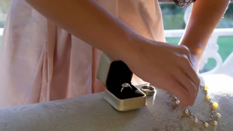 woman keeping wedding ring and necklace on the sofa 4k 4k