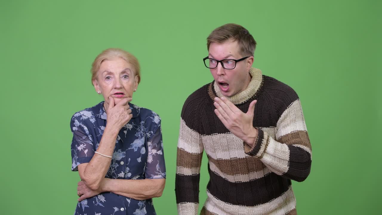 Grandmother and grandson looking shocked together