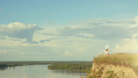 couple with balloons on a hilltop