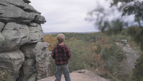 toddler gazing out over fall colored hills, slider r to l, slomo