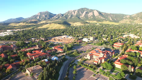 boulder, colorado landscape with the flat irons and chautauqua park in the background and the university of colorado boulder college campus in the foreground