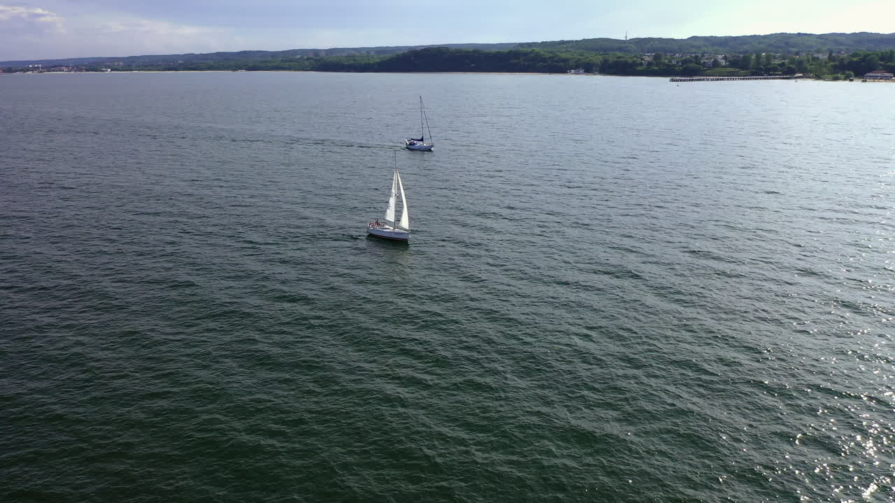 Aerial shot of drone flying above the ship sailing on the Baltic sea near Gdynia