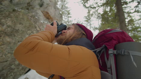 photographer taking pictures of mountains during hike