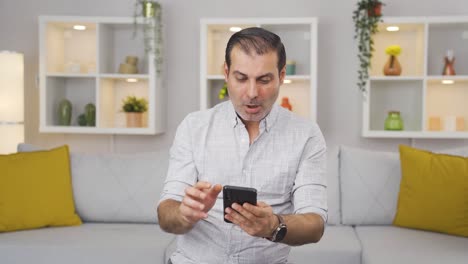 Happy-man-texting-on-the-phone.-Smiling.