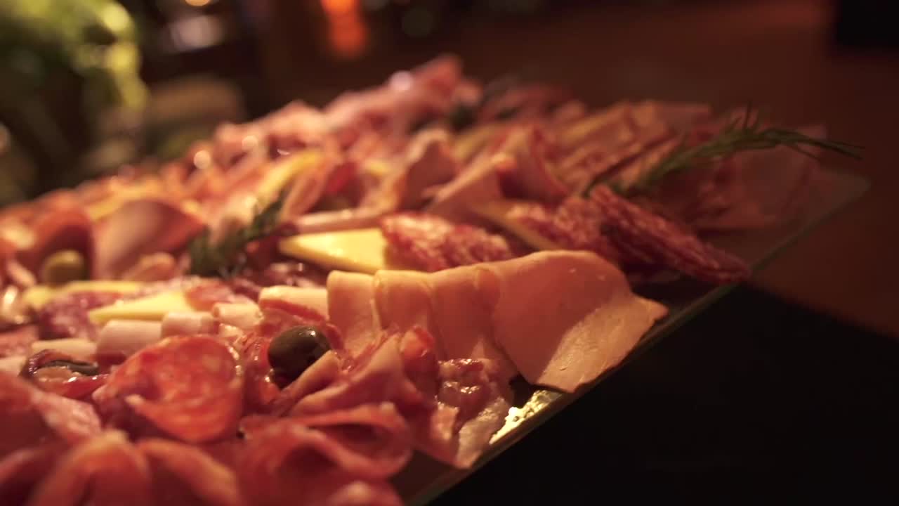 Close-up of gourmet Argentine charcuterie board with cured meats and cheese at elegant event