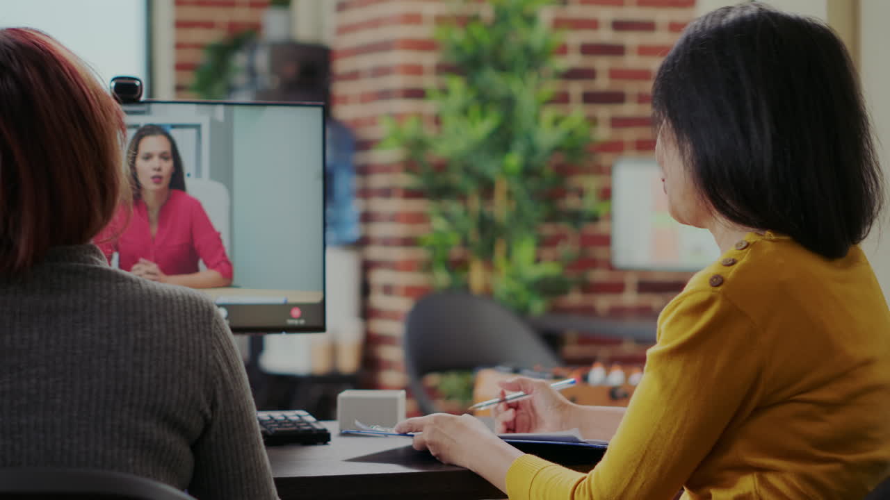 Coworkers interviewing candidate for job application on video conference