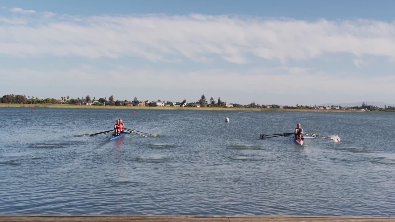 Four senior caucasian men and women rowing boat on a river