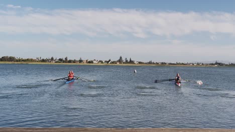 Four-senior-caucasian-men-and-women-rowing-boat-on-a-river