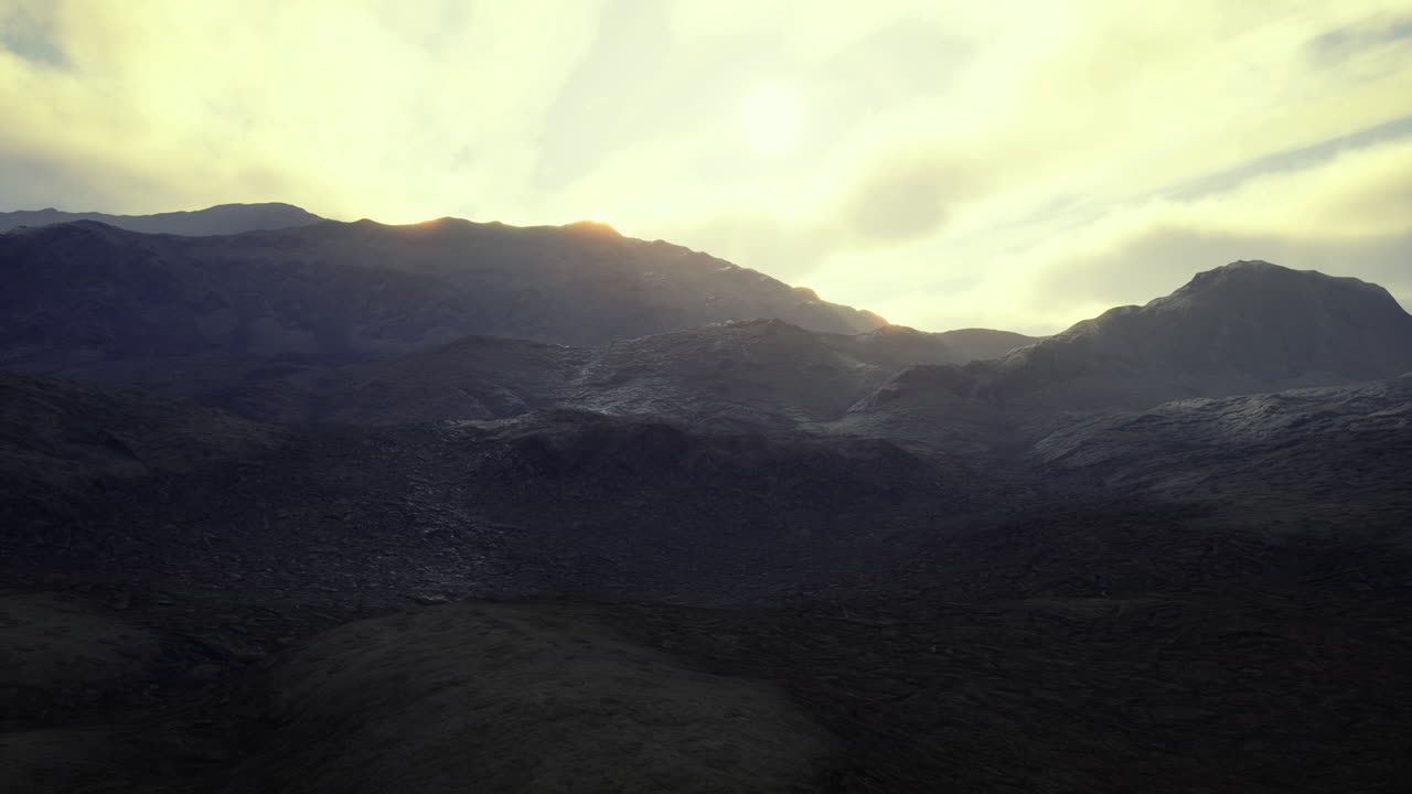 Majestic mountain landscape under a cloudy sky at sunset