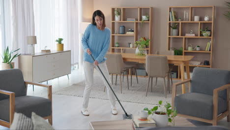 woman mopping the floor in a living room