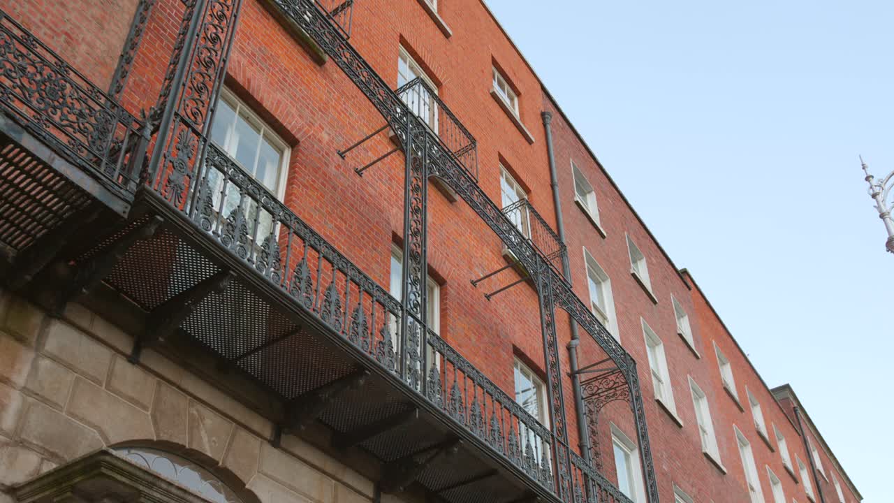 Building exterior with a black iron balcony, typical of Dublin architecture.