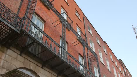 building exterior with a black iron balcony, typical of dublin architecture.