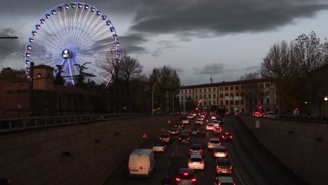 the ferris wheel illuminated during the christmas period at the amusement park at the fortezza da basso. italy.