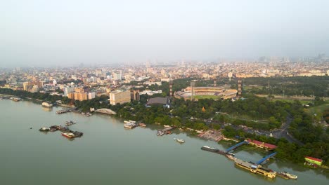 aerial drone shot of eden gardens during a match, with vibrant lights and a roaring crowd in kolkata.