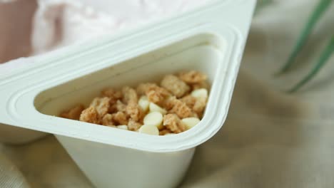 pink yogurt parfait in triangular container