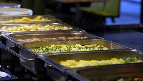 restaurant guests select food from a buffet