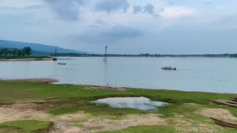 paddle and motorized tour boats setting off to explore river, sylhet bangladesh