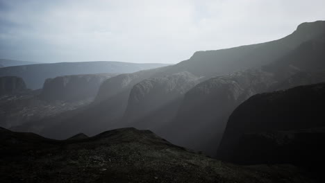 black mountains in deep fog