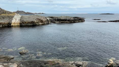 handheld panning shot of the spot where the storm swept holiday hytter into the sea in lofoten