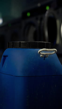 close up of a blue plastic container in a laundry room