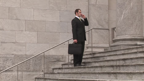 man on steps of building