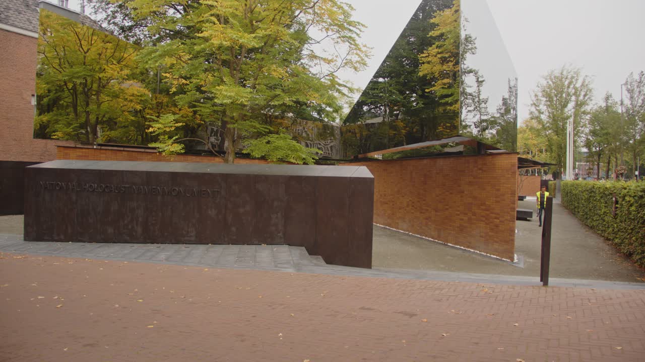 Entrance of the National Holocaust Names Memorial in Amsterdam, the Netherlands. A large reflecting mirror is on top of the monument